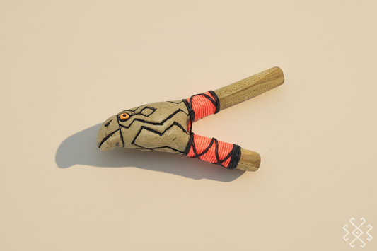 Handmade kuripe with tribal design on a beige background